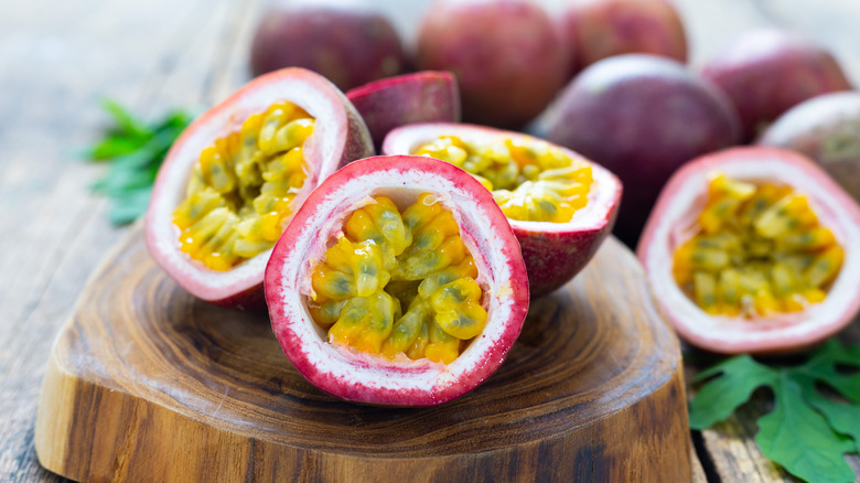 passion fruit ( maracuya ) with passion fruit cut in half slice on wooden table background .